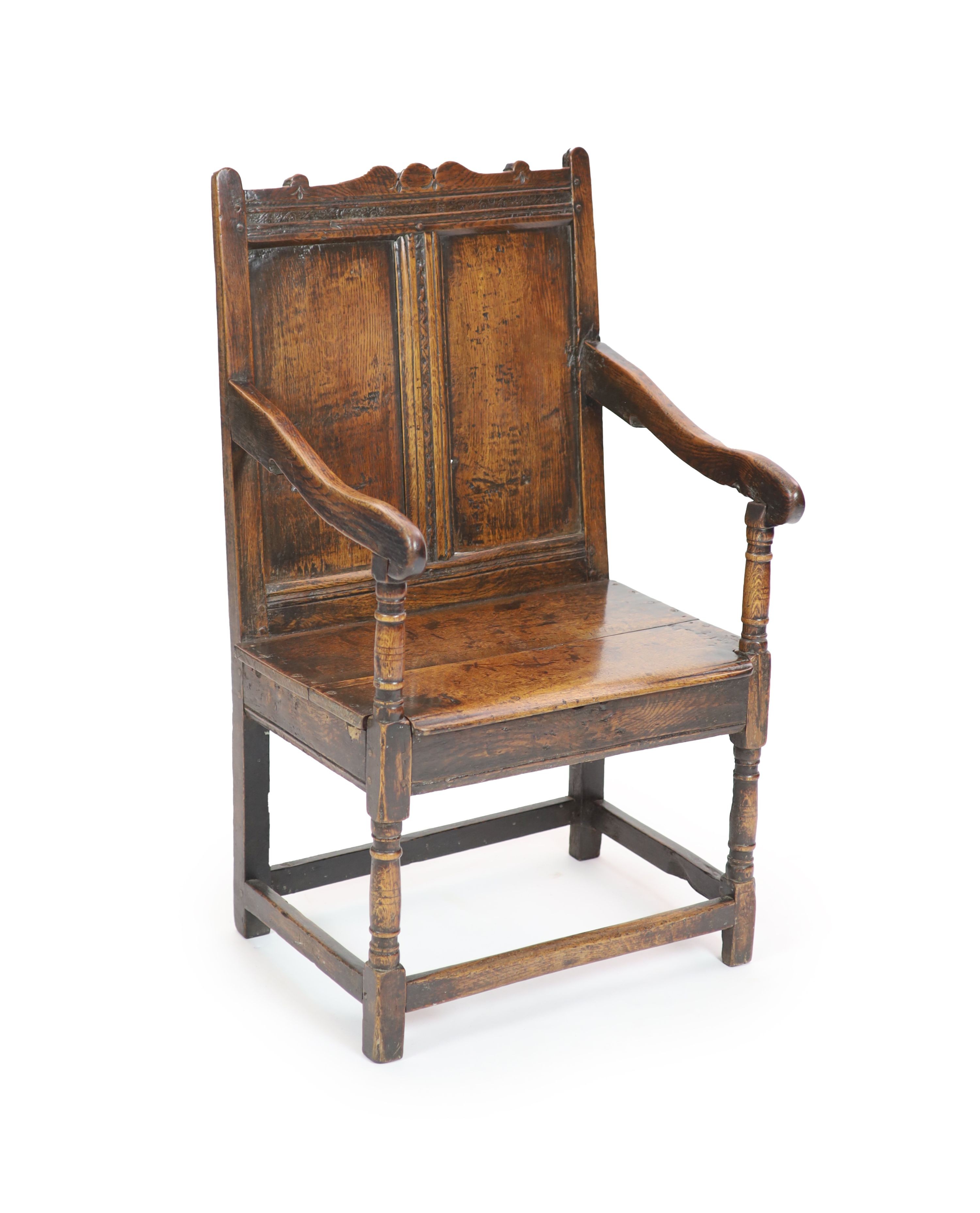 A 17th century oak open armchair, H 103cm. W 60cm. D 54cm.
